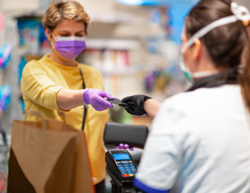 woman grocery shopping with mask on